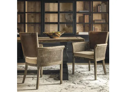 Poltroncina Anne con struttura in legno massello di Rovere, seduta imbottita rivestita in tessuto, schienale imbottito e rivestito in vera pelle con rilegatura in cuoio intrecciato e braccioli in cannettato intrecciato di Dialma Brown